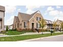 Beautiful brick home with a well-kept lawn, mature trees, and attractive stone retaining wall at 15628 Allegro Dr, Westfield, IN 46074