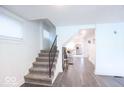 Hallway with staircase leading to kitchen, showcasing open floor plan at 1715 Fletcher Ave, Indianapolis, IN 46203