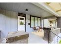 Inviting covered porch featuring seating and a stylish entrance door at 1715 Fletcher Ave, Indianapolis, IN 46203