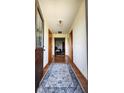 Inviting hallway with hardwood floors, decorative wallpaper, and wood trim at 18103 N 300 W, Summitville, IN 46070