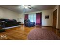 Cozy living room featuring hardwood floors, comfortable seating, and natural light at 18103 N 300 W, Summitville, IN 46070