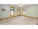 Spacious room featuring a light-blue wall color, carpeted floor, and wood trim at 241 S Walnut St, Jamestown, IN 46147