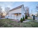 Side view of a cozy home featuring a covered patio and a well-maintained yard at 2639 Central Ave, Anderson, IN 46016