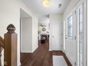 Inviting foyer with hardwood floors, white trim, and a view into the living room with a fireplace at 2895 Prairie Stream Way, Columbus, IN 47203