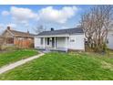 A quaint one-story house with a cozy front porch and a simple, inviting facade at 3710 Orchard Ave, Indianapolis, IN 46218