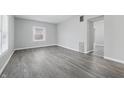 Bright, spacious living room with fresh paint, modern gray flooring, and abundant natural light at 3710 Orchard Ave, Indianapolis, IN 46218