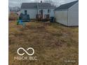Backyard featuring grass, a deck, and a detached garage at 3907 Haverhill Dr, Anderson, IN 46013