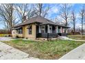 Bungalow-style home with a porch supported by columns and a quaint front yard near a city street at 3940 N Drexel Ave, Indianapolis, IN 46226