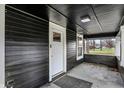 Covered front porch featuring classic siding and a welcoming entry with a view of the neighborhood street at 3940 N Drexel Ave, Indianapolis, IN 46226