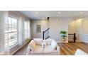 Bright living area with large windows, light wood floors, and a comfortable couch at 4271 Barrel Ln, Westfield, IN 46062