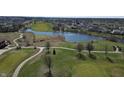 Scenic aerial view of a golf course community with a pond and well-maintained green spaces at 5233 Birmingham Dr, Indianapolis, IN 46235