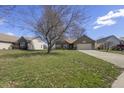Charming brick home featuring an attached two-car garage and a well-manicured lawn at 5233 Birmingham Dr, Indianapolis, IN 46235