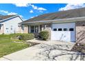 Well-maintained brick home with a one-car garage and lush front lawn at 5737 Misty Ridge Cir, Indianapolis, IN 46237