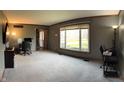 Bright, open living room features neutral carpeting and large windows at 5967 Oak Hill East Dr, Plainfield, IN 46168