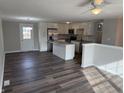 Open kitchen featuring white cabinets, stainless steel appliances, and an island with granite countertops at 6044 Granner Dr, Indianapolis, IN 46221