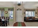 Welcoming foyer with hardwood floors, high ceilings and a view into the living spaces at 7233 Capel Dr, Indianapolis, IN 46259