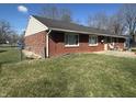 Spacious backyard featuring a well-maintained lawn and a classic brick facade at 731 W Stop 11 Rd, Indianapolis, IN 46217