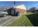 View of garage, driveway, and side of home with vinyl siding and brick at 731 W Stop 11 Rd, Indianapolis, IN 46217