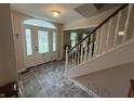 Welcoming foyer with tile flooring, decorative glass front door, and staircase at 7341 Campfire Run, Indianapolis, IN 46236