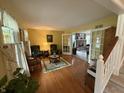 Inviting living room featuring hardwood floors, two chairs and a decorative area rug at 7341 Campfire Run, Indianapolis, IN 46236