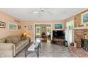 Comfortable living room with a brick fireplace, cozy sofa, and tiled floor at 7341 Campfire Run, Indianapolis, IN 46236