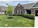 A quaint home featuring well-maintained landscaping and an inviting facade at 7447 Starkey Ct, Indianapolis, IN 46278