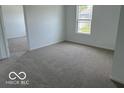 Comfortable bedroom with neutral carpeting and a large window offering ample natural light at 7549 Big Bend Blvd, Camby, IN 46113