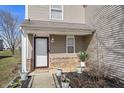 Inviting front porch adorned with potted plants, adding a touch of warmth and curb appeal at 8926 Poppy Ln, Indianapolis, IN 46231