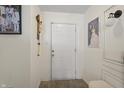 Inviting hallway with white walls, accented by tasteful decorations and warm, modern lighting at 8926 Poppy Ln, Indianapolis, IN 46231