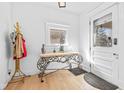 Bright entryway with light wood floors, decorative table, and coat rack at 935 N Tacoma Ave, Indianapolis, IN 46201