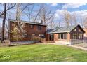 Charming log cabin-style home featuring a well-maintained lawn and natural surroundings at 98 Highland Manor S Ct, Indianapolis, IN 46228