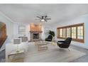 Inviting living room featuring a brick fireplace, large windows, and elegant, modern furnishings at 1143 N Sugar Bend Run, Greenfield, IN 46140