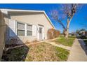 Inviting single-story home with a well-manicured lawn, mature trees, and an accessible sidewalk at 142 Norbeck Ter, Indianapolis, IN 46217