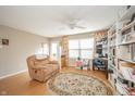Comfortable living area with a recliner chair, ceiling fan, and a warm, inviting atmosphere at 142 Norbeck Ter, Indianapolis, IN 46217