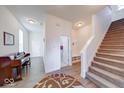 Bright foyer featuring a staircase, hardwood floors, and ample natural light at 14241 Antiquity Dr, Carmel, IN 46033