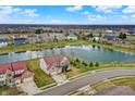 Expansive aerial view of the property showcasing the home, pond, and surrounding neighborhood at 14462 Camden Ln, Carmel, IN 46074
