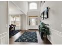 Elegant foyer with high ceilings, hardwood floors, stylish rug and natural light at 14462 Camden Ln, Carmel, IN 46074