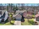 Charming two-story brick home featuring a well-maintained lawn and an attached two-car garage at 1450 Preston Ct, Greenwood, IN 46143