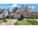 Charming two-story brick home featuring a well-maintained lawn and an attached two-car garage at 1450 Preston Ct, Greenwood, IN 46143