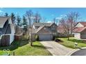 Charming two-story brick home featuring a well-maintained lawn and an attached two-car garage at 1450 Preston Ct, Greenwood, IN 46143
