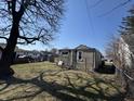 Home with fenced backyard featuring a grass lawn, perfect for outdoor activities and relaxation at 1515 S Emerson Ave, Indianapolis, IN 46203