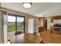 Bright kitchen with stainless steel appliances, wood cabinets, and a sliding glass door to enjoy indoor-outdoor living at 1585 S 600 W, New Palestine, IN 46163