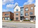Charming street view of new brick townhouses featuring colorful accents, neat landscaping, and a vibrant neighborhood feel at 1842 Central Ave, Indianapolis, IN 46202