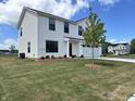 Attractive two-story home enhanced by the tree in the front yard and meticulous landscaping at 1862 Cascades Dr, Greenfield, IN 46140