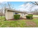 Side view of the home showing manicured bushes, green lawn and a fenced in yard at 2072 S Rembrandt Cv, Martinsville, IN 46151