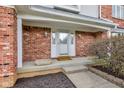 Inviting front porch with brick columns, elegant lighting, and decorative planters at 222 Wellington Pkwy, Noblesville, IN 46060