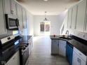 Modern kitchen with stainless steel appliances, granite countertops, and hardwood floors at 2249 Grand Fir Dr, Greenwood, IN 46143