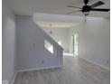 Modern living room with an open layout, light gray walls, hardwood floors, and modern lighting at 2249 Grand Fir Dr, Greenwood, IN 46143