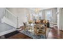 Elegant living room showcasing hardwood floors, a decorative rug, and staircase at 234 S State Ave, Indianapolis, IN 46201