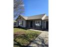 Inviting single-story home with a cozy front porch seating area and well-maintained lawn, adding to its curb appeal at 2509 Bristlecone Dr, Indianapolis, IN 46217